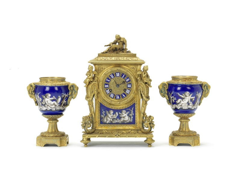 A late 19th century French ormolu and porcelain clock garniture