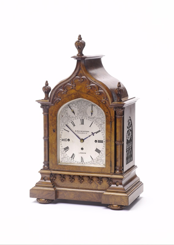 A late 19th century walnut quarter chiming mantel clock