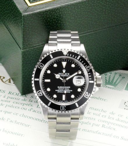Rolex. A fine stainless steel automatic centre seconds calendar bracelet watch together with fitted box and papers