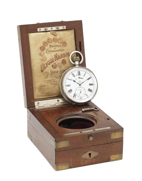 Ulysse Nardin. A silver keyless wind open face pocket watch with up and down dial in fixed wooden box