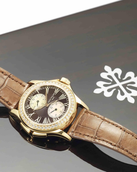 Patek Philippe. A fine and rare 18ct rose gold, diamond set and mother-of-pearl dual time zone lady's manual wind wristwatch