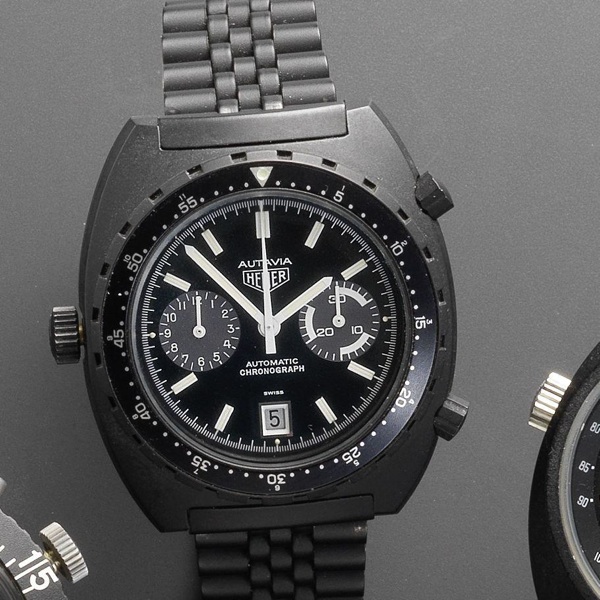 Heuer. A black PVD coated automatic calendar chronograph bracelet watch