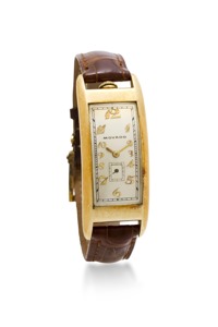 Movado. A 14K gold curved rectangular wristwatch