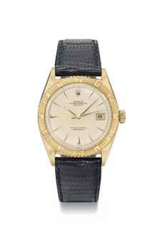 Rolex. An 18K gold automatic wristwatch with sweep centre seconds, date and Thunderbird bezel and cream dial