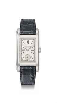 Patek Philippe. A rare and unusual stainless steel rectangular curved wristwatch with two-tone silvered dial