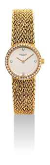 PATEK PHILIPPE. A LADY'S 18K GOLD AND DIAMOND-SET BRACELET WATCH