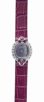 AUDEMARS PIGUET. A LADY'S ELEGANT 18K WHITE GOLD, DIAMOND AND RUBY-SET WRISTWATCH