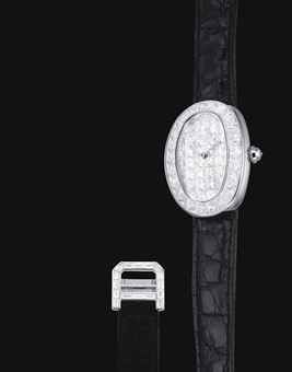 CARTIER. A LADY'S FINE AND RARE 18K WHITE GOLD AND DIAMOND-SET OVAL WRISTWATCH