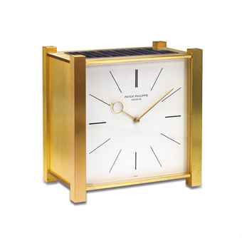 PATEK PHILIPPE. A FINE AND RARE GILT BRASS SQUARE SOLAR-POWERED DESK CLOCK