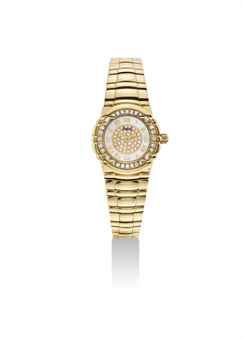 PIAGET. A LADY'S 18K GOLD AND DIAMOND-SET WRISTWATCH WTIH BRACELET AND MOTHER-OF-PEARL DIAL