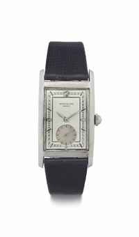 Patek Philippe. A Rare and Early Large Curved Rectangular Staybrite Steel Wristwatch with Original Box