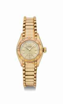 Rolex. A lady's 18K gold automatic wristwatch with cream honeycomb dial and bracelet