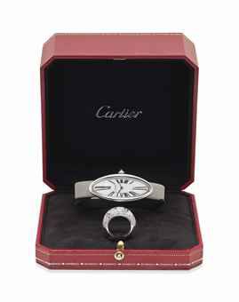 CARTIER. A LADY'S FINE 18K WHITE GOLD ELONGATED OVAL WRISTWATCH WITH AN 18K WHITE GOLD AND DIAMOND-SET COCKTAIL RING