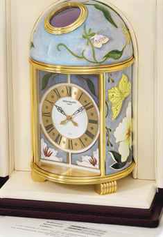 Patek Philippe. A very fine and unique gilt brass solar-powered table clock with cloisonne enamel by L. Rhee, certificate and presentation box