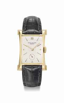 Patek Philippe. A fine and rare 18K gold rectangular wristwatch with sculpted lugs