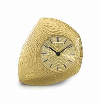 Patek Philippe. A fine, rare and unusual 18K gold asymmetrical keyless pendant lever watch with later gold chain