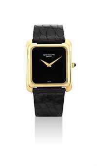 PATEK PHILIPPE. AN 18K GOLD RECTANGULAR WRISTWATCH WITH ONYX DIAL