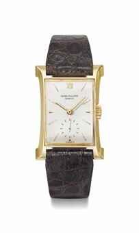 Patek Philippe. A fine and rare 18K gold rectangular wristwatch with sculpted lugs