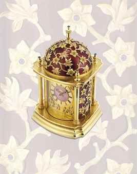 PATEK PHILIPPE. A MAGNIFICENT AND EXCEPTIONALLY RARE 18K VARI-COLOUR GOLD, RED ENAMEL AND SAPPHIRE-SET DOME TABLE CLOCK