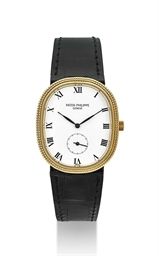 PATEK PHILIPPE. AN 18K GOLD OVAL WRISTWATCH WITH HOBNAIL BEZEL