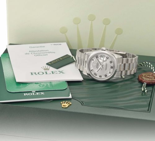 Rolex. A fine, rare and extremely attractive 18K white gold automatic wristwatch with Russian day indication, date, sweep centre seconds, diamond-set dial, bracelet, certificate and box