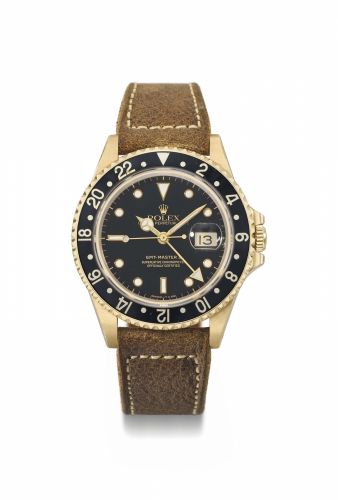 Rolex. A fine 18K gold automatic dual time sweep centre seconds wristwatch with date