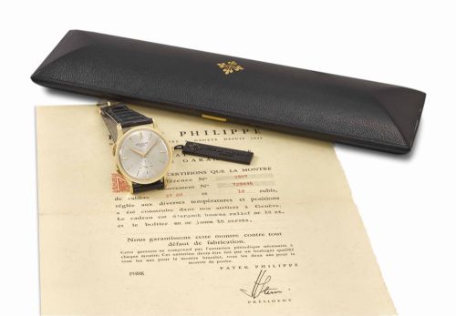 Patek Philippe. An extremely fine and very rare 18K gold dual time zone wristwatch with separately adjustable hour hand, Certificate of Origin, envelope, sales tag and box