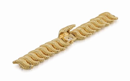 Patek Philippe. A lady's unusual, heavy and rare 18K gold bracelet watch with concealed dial