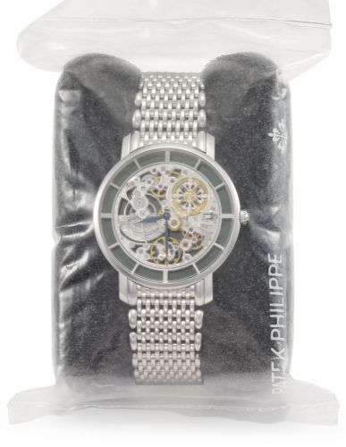 Patek Philippe. A very fine and rare 18K white gold skeletonized automatic wristwatch with bracelet, original certificate and box, factory sealed