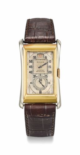 Rolex. A fine two-colour 18K yellow and white gold rectangular wristwatch with jumping hour and box