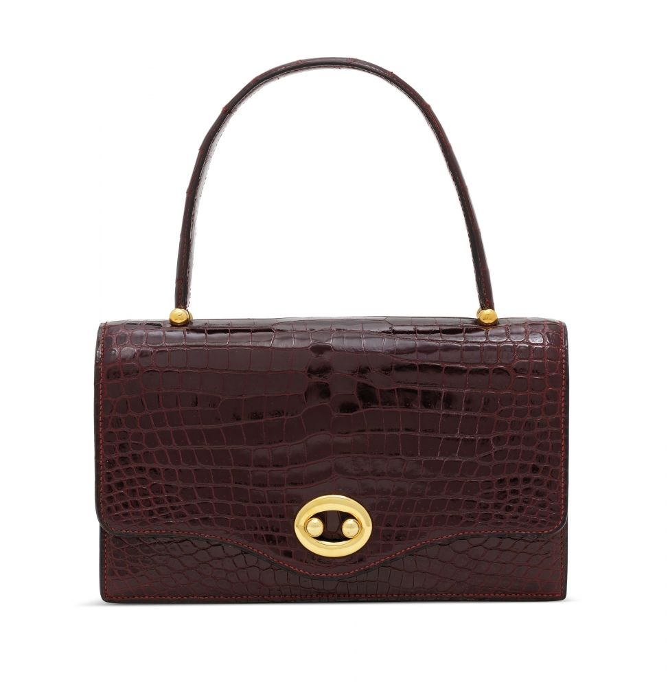 A SHINY BORDEAUX POROSUS CROCODILE SAC BOUTONNIÈRE WITH GOLD HARDWARE