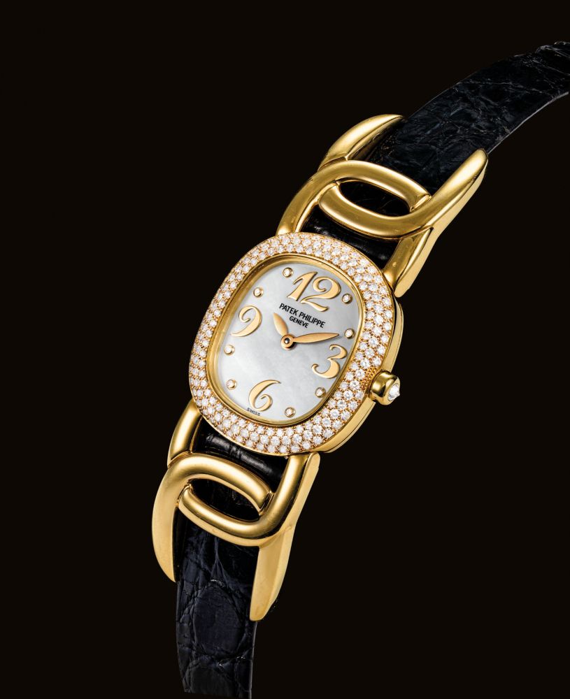 PATEK PHILIPPE. A LADY'S FINE 18K GOLD AND DIAMOND-SET OVAL WRISTWATCH WITH MOTHER-OF-PEARL DIAL