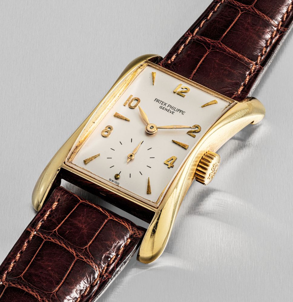 PATEK PHILIPPE. A FINE AND RARE 18K GOLD RECTANGULAR WRISTWATCH WITH FLARED SIDES