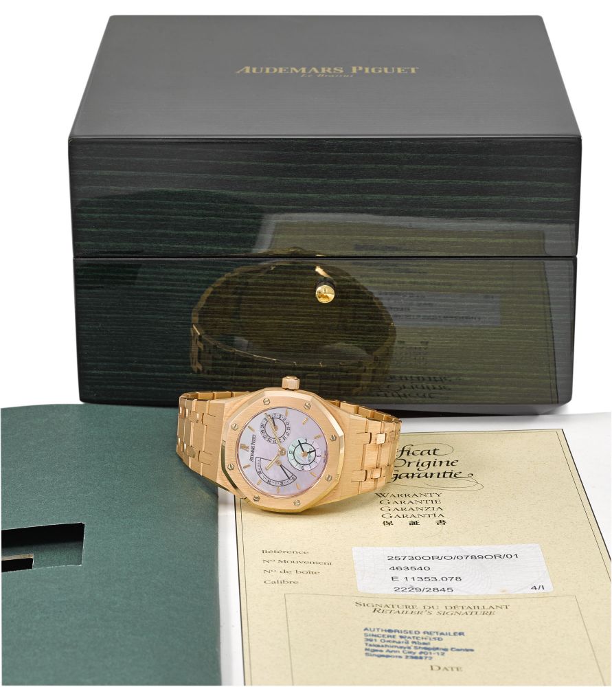 Audemars Piguet. A very fine, rare and attractive 18K pink gold automatic dual time wristwatch with power reserve, pink mother-of-pearl dial, original certificate and box