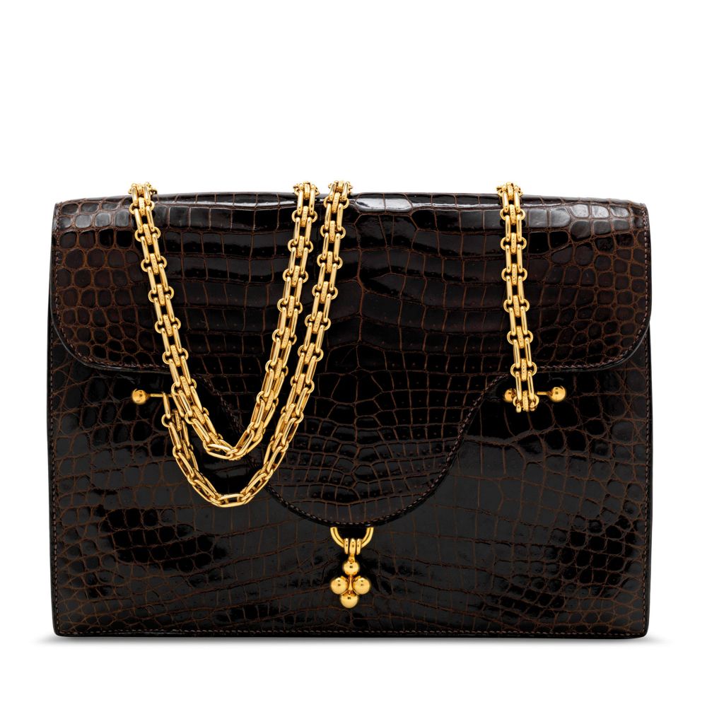 A SHINY MARRON FONCÉ POROSUS CROCODILE LOTO WITH GOLD HARDWARE - HERMÈS, 1962