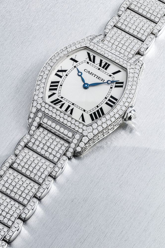 CARTIER. A RARE 18K WHITE GOLD AND DIAMOND-SET TONNEAU-SHAPED WRISTWATCH WITH BRACELET