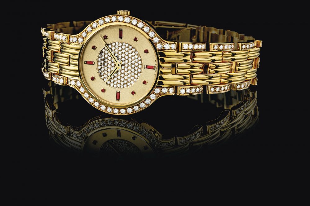 PATEK PHILIPPE. AN 18K GOLD, DIAMOND AND RUBY-SET BRACELET WATCH