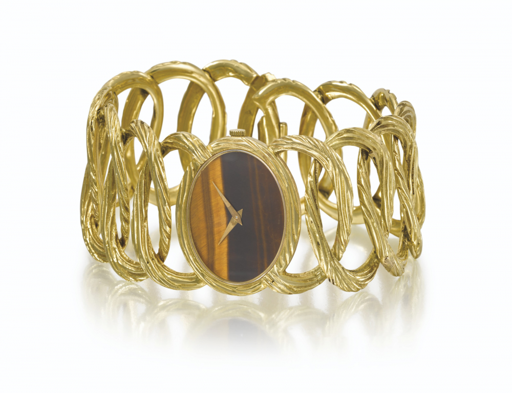 PIAGET. AN ELEGANT 18K GOLD BRACELET WATCH WITH TIGER'S EYE DIAL