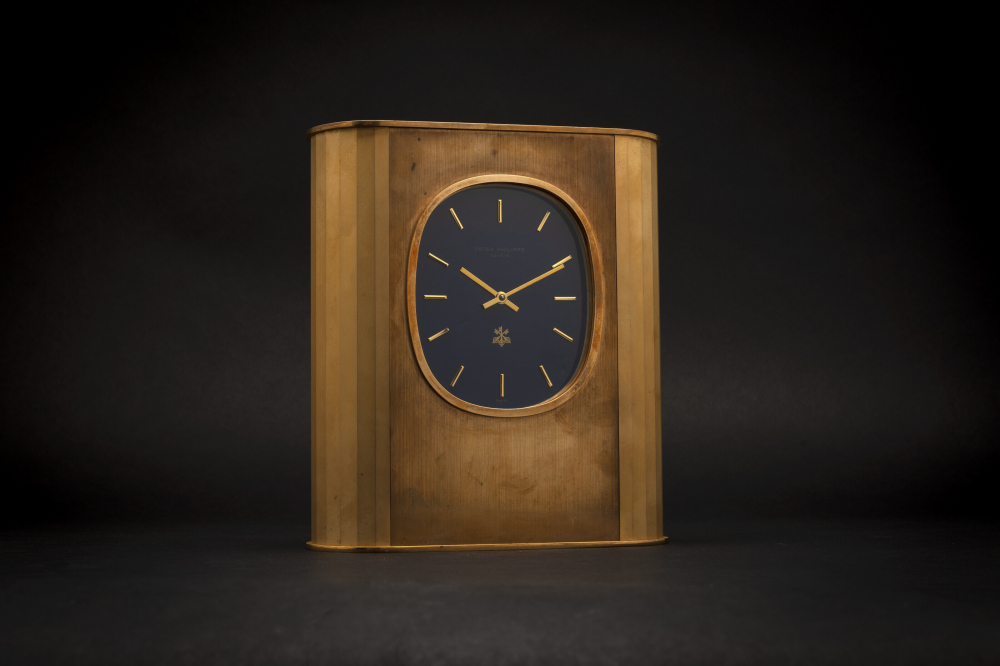 PATEK PHILIPPE, SOLAR-POWERED DESK CLOCK, GILT BRASS, “ELLIPSE D’OR”, REF. 1505" - CASE