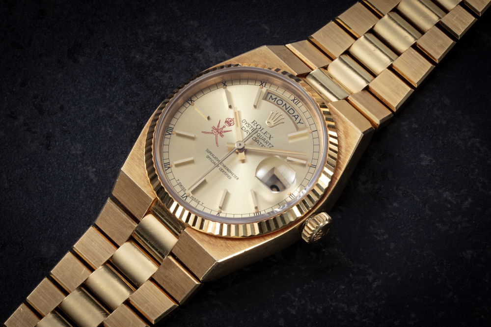 ROLEX, DAY-DATE OYSTERQUARTZ REF. 19018 'CROWN KHANJAR', AN UNUSUAL GOLD QUARTZ WRISTWATCH WITH DOUBLE STAMPED NATIONAL SYMBOL OF OMAN, CASE NUMBER: 6'257'356 | Christie’s