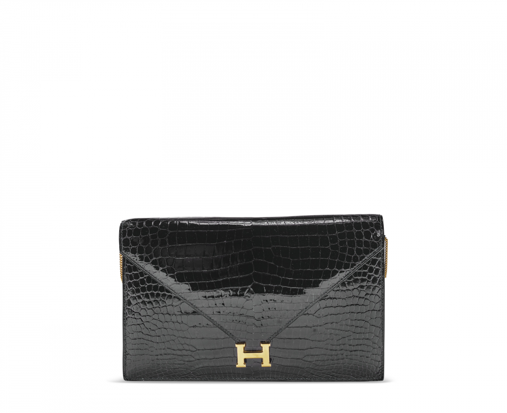 A SHINY BLACK POROSUS CROCODILE LYDIE WITH GOLD HARDWARE - HERMÈS