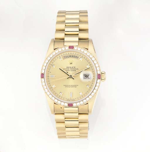 ROLEX, AN 18ct. GOLD DIAMOND AND RUBY SET DAY-DATE AUTOMATIC CENTRE SECONDS WRISTWATCH.signed Rolex Oyster Perpetual Day-Date, superlative Chronometer Officially Certified, Ref: 18378, circa 2000.