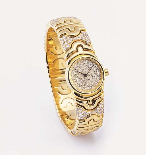 BULGARI. A LADY'S 18K GOLD AND DIAMOND-SET BANGLE-WATCH