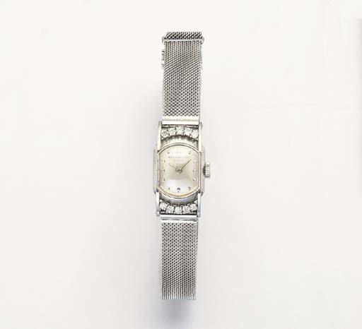 PATEK PHILIPPE. A LADY'S 18K WHITE GOLD AND DIAMOND-SET OVAL WRISTWATCH