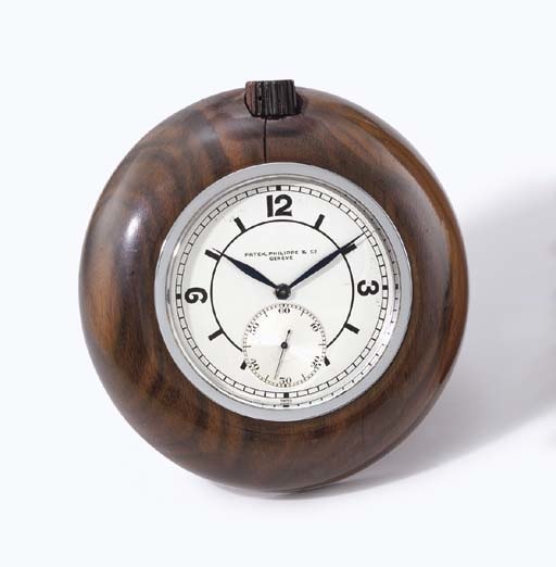 Patek Philippe. A fine and very rare stainless steel and Madagascar ebony desk timepiece with sector dial, usable as desk clock or paper weight