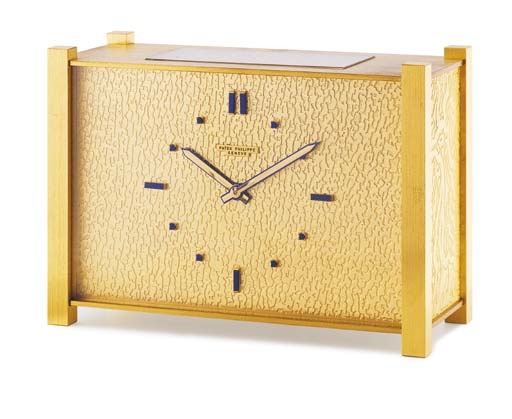 PATEK PHILIPPE. A RARE AND UNUSUAL GILT BRASS AND LAPIS LAZULI-SET SOLAR POWERED DESK CLOCK
