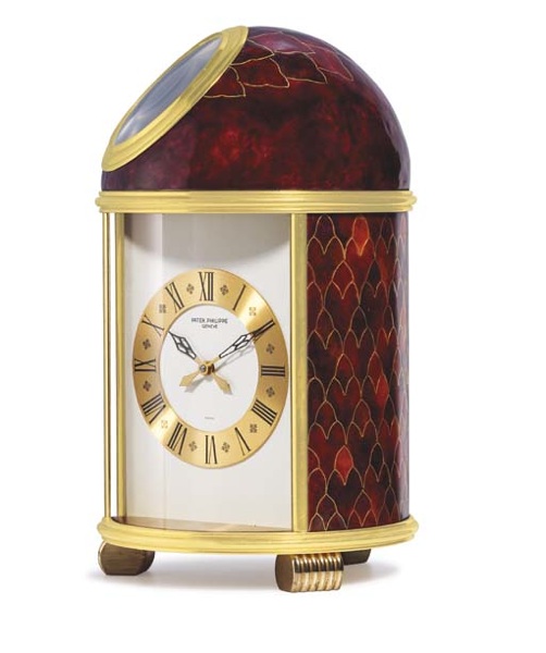 PATEK PHILIPPE. A FINE AND UNIQUE GILT BRASS SOLAR POWERED TABLE CLOCK WITH CLOISONNE ENAMEL BY ELISABETH PERUSSET LAGGER