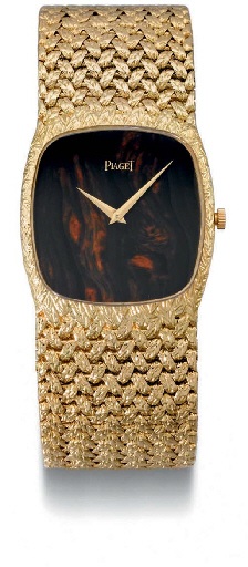 Piaget. An 18K gold wristwatch with tiger's eye dial and bracelet