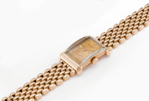 Patek Philippe. A fine, rare and unusual 18K pink gold rectangular wristwatch with pink dial, hooded lugs and bracelet