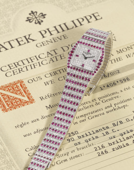 PATEK PHILIPPE. A FINE AND RARE LADY'S 18K WHITE GOLD, DIAMOND AND RUBY-SET WRISTWATCH WITH BRACLET AND ORIGINAL CERTIFICATE